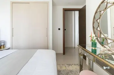 a bedroom with a bed and a mirror at Frank Porter - Sobha Creek Tower B in Dubai
