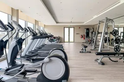 a gym with treadmills and machines in a room at Frank Porter - Sobha Creek Tower B in Dubai