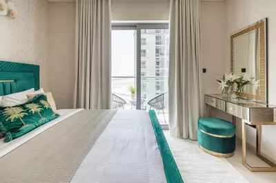 a bedroom with a bed and a desk and a window at Frank Porter - Sobha Creek Tower B in Dubai