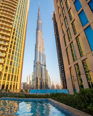a pool in the middle of a city with skyscrapers at Luxury 2BR Sea & Skyline Views Near Metro & Burj Khalifa in Dubai