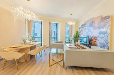a living room with a couch and a dining room at Luxury 2BR Sea & Skyline Views Near Metro & Burj Khalifa in Dubai