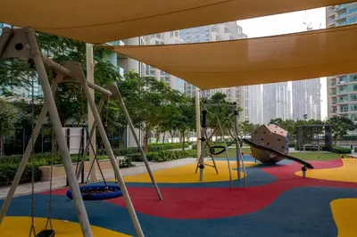 a playground with a slide and a swing at Luxury 2BR Sea & Skyline Views Near Metro & Burj Khalifa in Dubai