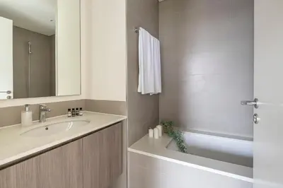 a bathroom with a sink and a bath tub at Frank Porter - Park Ridge C in Dubai
