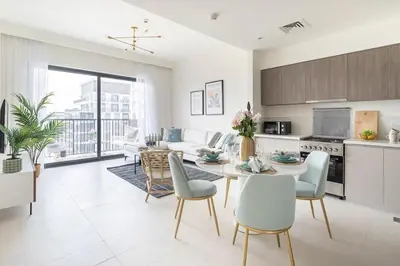 a kitchen and living room with a table and chairs at Frank Porter - Park Ridge C in Dubai