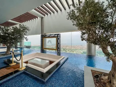 a swimming pool with a tub in a house with trees at Luton Vacation Homes - Damac Paramount Midtown Business Bay Dubai - 37AB09 in Dubai