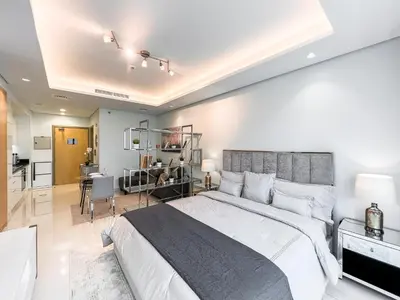 a large bedroom with a large bed and a kitchen at Luton Vacation Homes - Damac Paramount Midtown Business Bay Dubai - 37AB09 in Dubai