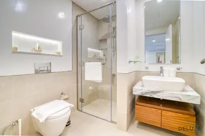 a bathroom with a toilet and a sink and a shower at Exclusive Deal Stunning 1BR at Madinat Jumeirah by Deluxe Holiday Homes in Dubai