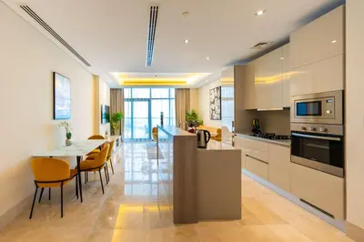 a kitchen and dining room with a table and chairs at Spacious beachfront 2 bedroom apartment - The 8 in Dubai