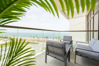 a balcony with chairs and a view of the ocean at Spacious beachfront 2 bedroom apartment - The 8 in Dubai