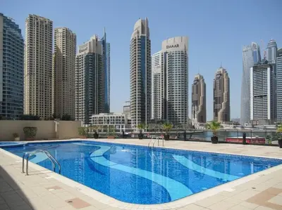 a large swimming pool in front of a city skyline at Frank Porter - Marina Views B in Dubai