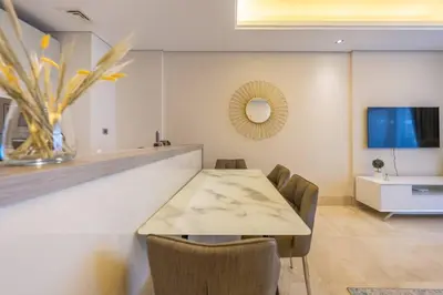 a dining room with a table and chairs at Cozy beachfront 1 bedroom apartment - The 8 in Dubai