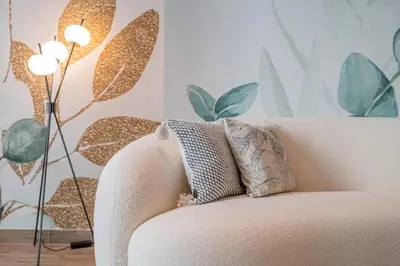 a white couch with a pillow and a lamp at Desert Living Luxury Condo - Jumeirah Living Marina Gate in Dubai