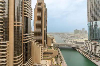 a view of a city with tall buildings and a river at Vacay Lettings - 2BHK with Dubai Marina View in Dubai