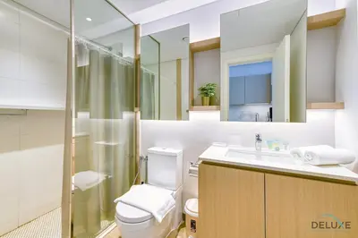a bathroom with a toilet and a sink and a shower at Cheerful Studio at Belgravia Tower JVC by Deluxe Holiday homes in Dubai