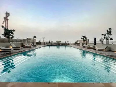 a large swimming pool on top of a building at White Sage - Elegant Apartment With Unobstructed City Views in Dubai