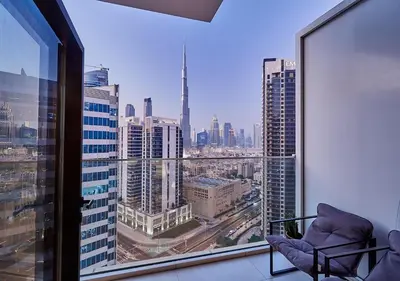 a room with a window with a view of a city at Luxury Studios with Burj Khalifa View or Canal view - Marquise Square Tower in Dubai