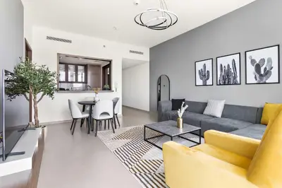 a living room with a couch and a table at Silkhaus modern Boulevard 1BDR near Burj Khalifa in Downtown in Dubai