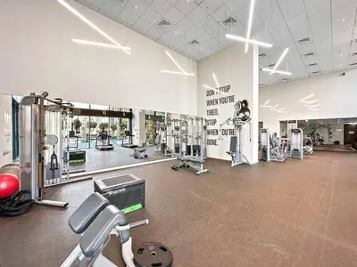a large gym with equipment in a large room at Silkhaus modern Boulevard 1BDR near Burj Khalifa in Downtown in Dubai