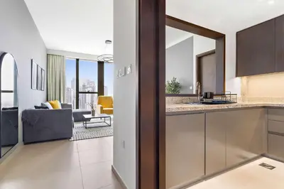 a kitchen and living room with a view of a living room at Silkhaus modern Boulevard 1BDR near Burj Khalifa in Downtown in Dubai