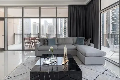 a living room with a couch and a table at Frank Porter - Boulevard Crescent in Dubai