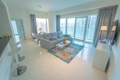 a living room with a couch and a table at AWS Holiday Homes - Unique Views at Damac Heights in Dubai