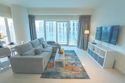 a living room with a couch and a table at AWS Holiday Homes - Unique Views at Damac Heights in Dubai