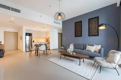 a living room with a couch and a table at Daniels 1BR at Creek Horizon with Park View in Dubai