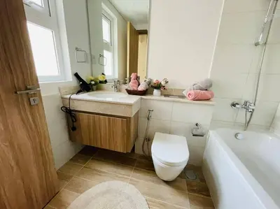 a bathroom with a toilet and a sink and a tub at Elite Inn: Amaranta75 (Townhouse Direct pool view) in Dubai