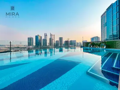 a swimming pool with a city skyline in the background at Mira Holiday Homes - Furnished studio in Downtown in Dubai