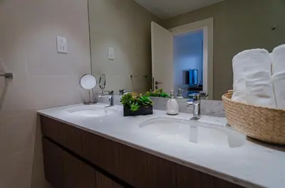 a bathroom with two sinks and a mirror at Outstanding New Apartment with Sea View In La Mer in Dubai