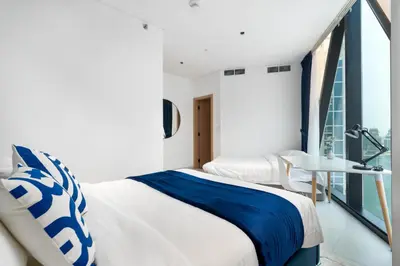 a bedroom with a bed and a window at Ultimate Stay / 4 Beds / Burj Khalifa View / Ultra Modern / Business Bay in Dubai