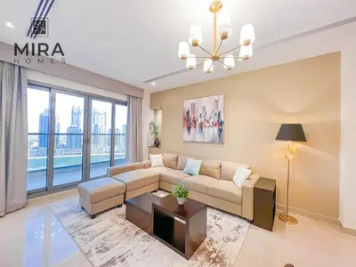 a living room with a couch and a table at Mira Holiday Homes - Lovely 1 bedroom apartment in Downtown in Dubai