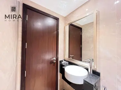 a bathroom with a sink and a wooden door at Mira Holiday Homes - Lovely 1 bedroom apartment in Downtown in Dubai