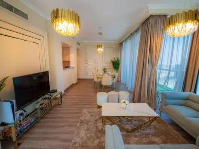 a living room with a couch and a table at Stylish 3BR Burj Khalifa, Fountain Views, Pool & Prime Location in Dubai