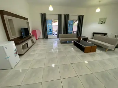a large living room with a couch and a tv at Comfortable Private Rooms in Compound Housing in Dubai