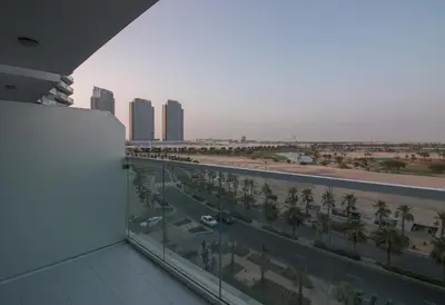 a balcony with a view of a highway and buildings at Premium Studio with Beautiful Golf Course View in Dubai