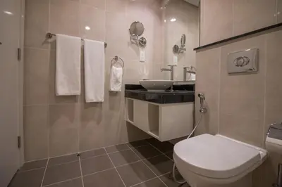 a bathroom with a white toilet and a sink at Premium Studio with Beautiful Golf Course View in Dubai