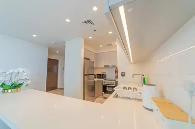 a kitchen with a white counter top and a room at FIRST CLASS 2BR with full DUBAI BOULEVARD view in Dubai