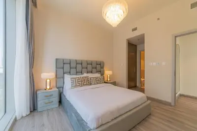 a bedroom with a large bed and two lamps at FIRST CLASS 2BR with full DUBAI BOULEVARD view in Dubai