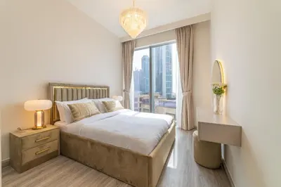a bedroom with a bed and a large window at FIRST CLASS 2BR with full DUBAI BOULEVARD view in Dubai