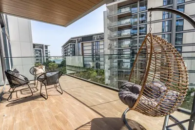 a hammock on a balcony with a view of a building at GuestReady - Stunning Apartment in Bluewaters in Dubai