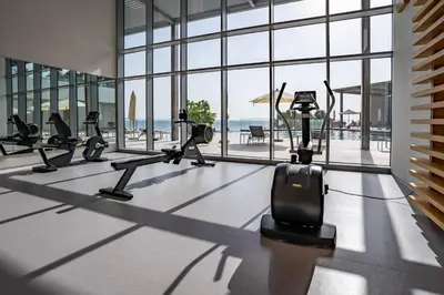 a gym with cardio machines and a view of the ocean at GuestReady - Stunning Apartment in Bluewaters in Dubai