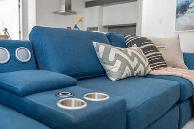 a blue couch with two silver plates on it at GuestReady - Stunning Apartment in Bluewaters in Dubai