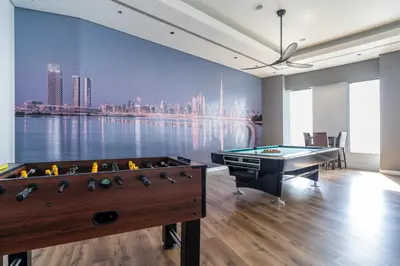a billiard room with a view of the city at Veer Apartments - 82nd Floor Princess Tower - Palm View in Dubai