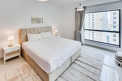 a bedroom with a large bed and a large window at 2 BD apartment in Bahar JBR in Dubai
