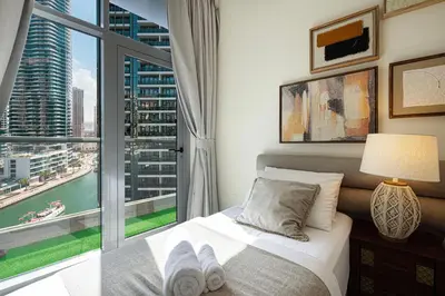 a bedroom with a bed and a large window at Stylish 3 bedrooms Boho-Style Home in Dubai