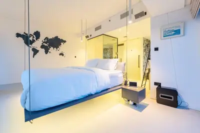 a bedroom with a large bed and a mirror at Cayan old in Dubai