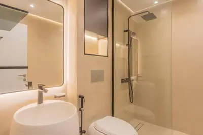 a bathroom with a toilet and a sink and a shower at Cayan old in Dubai