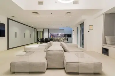 a living room with a large couch and a table at Cayan old in Dubai