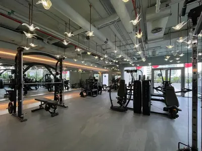 a gym with lots of treadmills and machines at GuestReady - Charming Loft 7mins from Burj Khalifa in Dubai